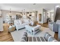 Bright, open-concept living room featuring hardwood floors and an inviting color palette at 5486 Summer Sunset Dr, Apollo Beach, FL 33572