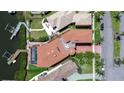 Aerial view of a luxury home with a private dock and screened pool at 6201 Marbella Blvd, Apollo Beach, FL 33572