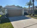 Single-story home with a spacious driveway and a well-maintained lawn at 7326 Cutwater Ln, Wesley Chapel, FL 33545