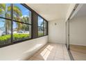 Enclosed lanai with tile floor and sliding glass door access to the living area at 7701 Starkey Rd # 445, Seminole, FL 33777