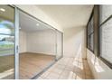 View of enclosed lanai with tile floor, sliding glass door and the living area beyond at 7701 Starkey Rd # 445, Seminole, FL 33777