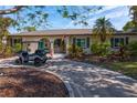 Charming home with a well-maintained lawn, mature landscaping, and a welcoming front porch at 843 37Th Ne Ave, St Petersburg, FL 33704