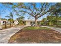 Well-manicured home with a lush front lawn, mature landscaping, and a inviting curb appeal at 843 37Th Ne Ave, St Petersburg, FL 33704