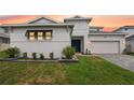 Charming two-story home with landscaped yard, brick driveway, and attached two-car garage at 8946 Ivy Stark Blvd, Wesley Chapel, FL 33545