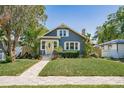 Charming home with a well-manicured lawn and a welcoming yellow front door at 930 23Rd N Ave, St Petersburg, FL 33704