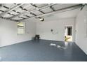 An attached garage with painted block walls and a sealed floor at 930 57Th N Ave, St Petersburg, FL 33703