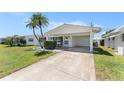 Inviting home featuring a covered carport, well-kept lawn, and a welcoming front entrance at 9740 45Th N St, Pinellas Park, FL 33782