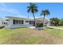 A cozy single-story home featuring a covered carport, well-kept lawn, and tasteful landscaping at 9740 45Th N St, Pinellas Park, FL 33782