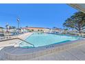 Large in ground pool with clean shimmering water, surrounded by lounge seating at 9740 45Th N St, Pinellas Park, FL 33782