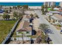 Aerial view showcases a charming house near the beach and the ocean in the background at 103 146Th E Ave, Madeira Beach, FL 33708