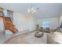 Spacious living room with staircase, neutral color palette, modern furniture, and ample natural light at 10906 Kenbrook Dr, Riverview, FL 33578