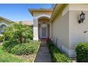 Inviting front entrance featuring a well-manicured landscape and a charming front door at 11147 Brambleleaf Way, Hudson, FL 34667