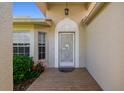 Welcoming front porch with brick flooring and a decorative glass front door, providing great curb appeal at 11147 Brambleleaf Way, Hudson, FL 34667