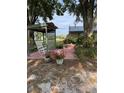 Backyard sitting area with a white rocking chair and brick patio, offering a cozy outdoor retreat at 125 S Wiggins Rd, Plant City, FL 33566