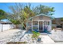 Charming cottage with a front porch, light blue shutters and a quaint compass decoration at 1507 Legion Ln, Indian Rocks Beach, FL 33785