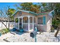 Charming cottage with a front porch, light blue shutters and a mailbox at 1507 Legion Ln, Indian Rocks Beach, FL 33785