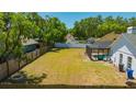 The fully fenced backyard includes a fire pit and a screened-in pool area at 18238 Clear Lake Dr, Lutz, FL 33548