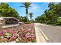 Villa Rosa entrance featuring a beautiful flower garden underneath community signage at 19505 Morden Blush Dr, Lutz, FL 33558