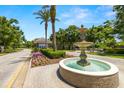 Decorative community fountain with surrounding greenery under a clear blue sky at 19505 Morden Blush Dr, Lutz, FL 33558