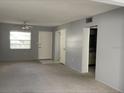Spacious living room with neutral paint, carpet and ample natural light at 1975 W Bay Dr # 207, Largo, FL 33770