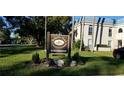 Belleair Oaks Condominiums sign surrounded by lush green grass and manicured landscaping at 1975 W Bay Dr # 207, Largo, FL 33770