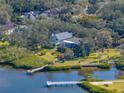 Beautiful waterfront home with a private dock and lush green backyard, offering serene water views at 3484 Shore Dr, Safety Harbor, FL 34695
