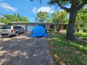 Home exterior featuring a brick facade, driveway, landscaping and front door at 3714 E Ellicott St, Tampa, FL 33610