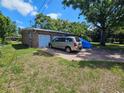 Exterior shot of a two car garage and van parked in the driveway at 3714 E Ellicott St, Tampa, FL 33610