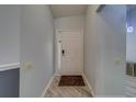 Inviting entryway featuring light gray walls, white trim, and a modern light-colored wood floor at 39650 Us Highway 19 N # 743, Tarpon Springs, FL 34689