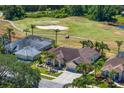 Beautiful aerial shot of a home on a golf course with mature trees and landscaping at 5113 Epping Ln, Zephyrhills, FL 33541