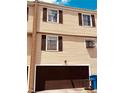 View of the exterior of the home featuring an attached garage and traditional shuttered windows at 5407 Sweetwater Terrace Cir # 5407, Tampa, FL 33634