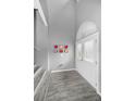 Bright foyer with wood-look tile flooring and staircase at 5807 Cay Cove Ct, Tampa, FL 33615