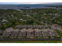 Excellent aerial view of property, showing neighborhood, pond, and proximity to the bay at 597 Ozona Village Dr, Palm Harbor, FL 34683