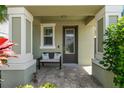 Inviting front porch with seating and lush greenery at 597 Ozona Village Dr, Palm Harbor, FL 34683