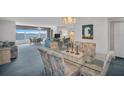 Open-concept living room with a dining area featuring a bay window and water view at 5980 Shore S Blvd # 403, Gulfport, FL 33707