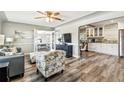 Bright living room with hardwood flooring, modern furniture, ceiling fan, and views into dining and kitchen at 6207 Gulfport S Blvd, Gulfport, FL 33707