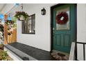 Close-up of the front porch with a festive wreath and hanging flower baskets at 6535 3Rd S Ave, St Petersburg, FL 33707