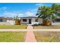 Charming home with a well-manicured lawn and inviting walkway to the front door at 6535 3Rd S Ave, St Petersburg, FL 33707