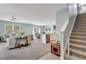 Open-concept living area with staircase and seamless flow to the dining and kitchen at 6648 Seaway Dr, Brooksville, FL 34604