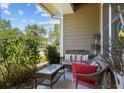 Outdoor seating on the cozy porch, perfect for relaxing and enjoying nature at 6922 Duffy Ln, Tampa, FL 33616
