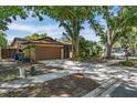Single-Gathering home with a well-maintained lawn, a two-car garage, and a screened front entry at 740 Crystal Dr, Palm Harbor, FL 34683