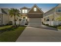 Exterior of home with front lawn and two-car garage at dusk at 7509 S Sherrill St, Tampa, FL 33616