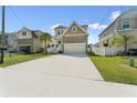 Suburban home with wide driveway, stone facade and palm tree in the front yard at 7509 S Sherrill St, Tampa, FL 33616