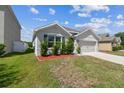 Single-story home with well-maintained lawn and landscaping at 8105 Bilston Village Ln, Gibsonton, FL 33534