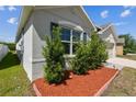 Close up showing manicured landscaping and the exterior of the home at 8105 Bilston Village Ln, Gibsonton, FL 33534