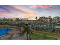 Enjoy poolside relaxation at this waterfront property with boat docks and lush landscaping at 936 Pinellas Bayway S # T-5, Tierra Verde, FL 33715