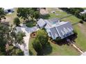 Picturesque aerial view showcasing the home, expansive lawn, mature trees, and a sparkling pool in a fenced-in area at 10101 Bryant Rd, Lithia, FL 33547