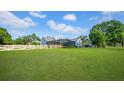 The backyard has a long, white country style fence and screened in pool area at 10101 Bryant Rd, Lithia, FL 33547