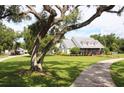 Charming home with a well-manicured lawn, mature trees, and a circular driveway at 10101 Bryant Rd, Lithia, FL 33547