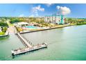 Waterfront property showing dock, pool, and well-maintained landscaping with a stunning building at 10215 Regal Dr # 41, Largo, FL 33774